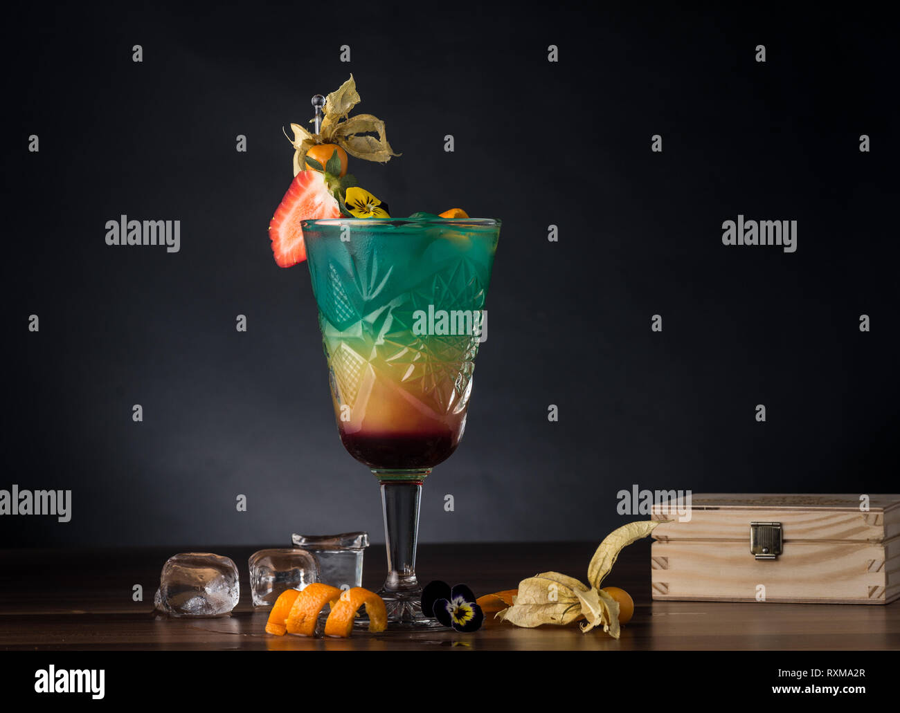 Cocktail de couleur sombre sur fond de bois. Banque D'Images