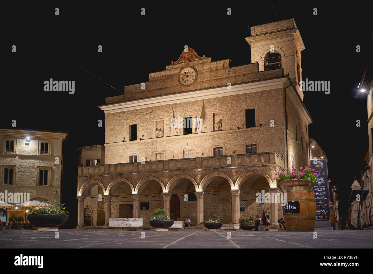 Foligno, Italie - juillet 2018. Une vue de la nuit de la 13e siècle Palazzo Comunale (Mairie) sur la place principale de la ville médiévale de Montefalco. Banque D'Images