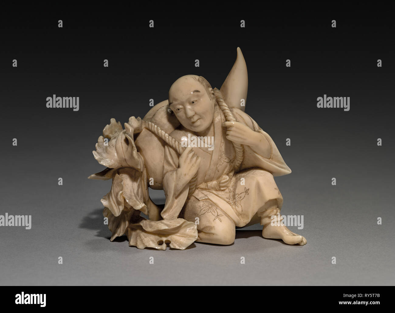 Homme portant un grand légume, fin des années 1800- début des années 1900. Le Japon de la fin du xixe- début du xxe siècle. L'ivoire ; total : 6,7 cm (2 5/8 po Banque D'Images