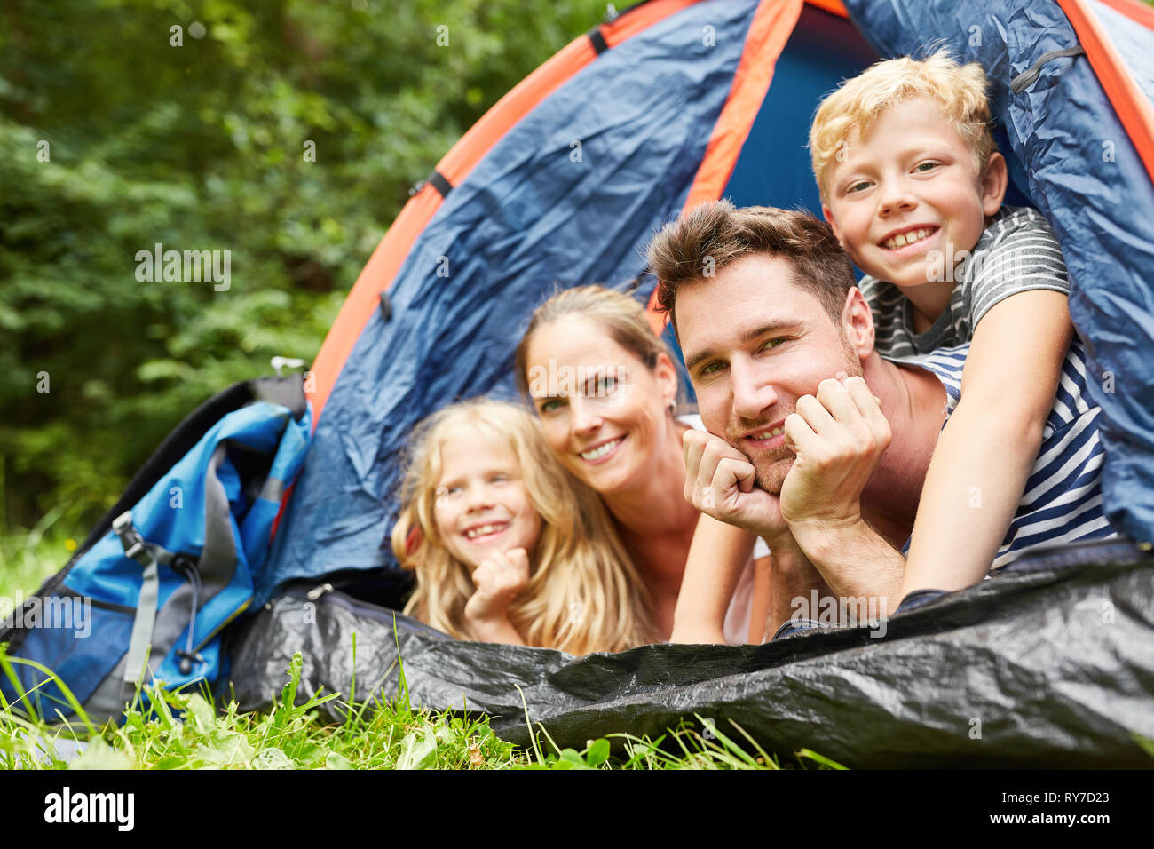 Famille heureuse avec deux enfants camping en tente en été locations Banque D'Images