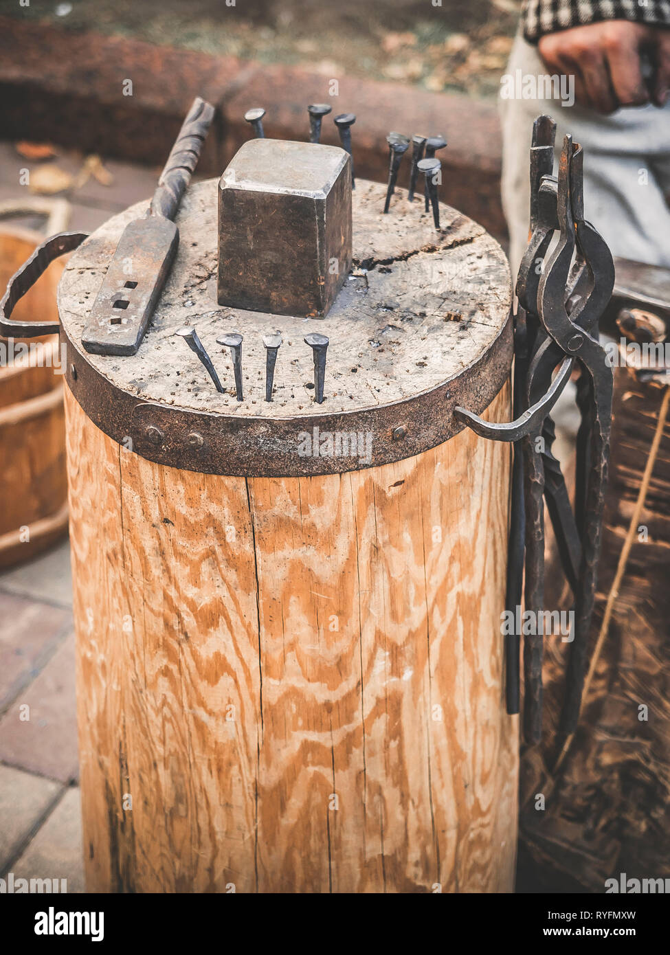 Outils pour le travail du forgeron. Le marteau et l'enclume et autres outils piscine fond d'herbe verte. Banque D'Images
