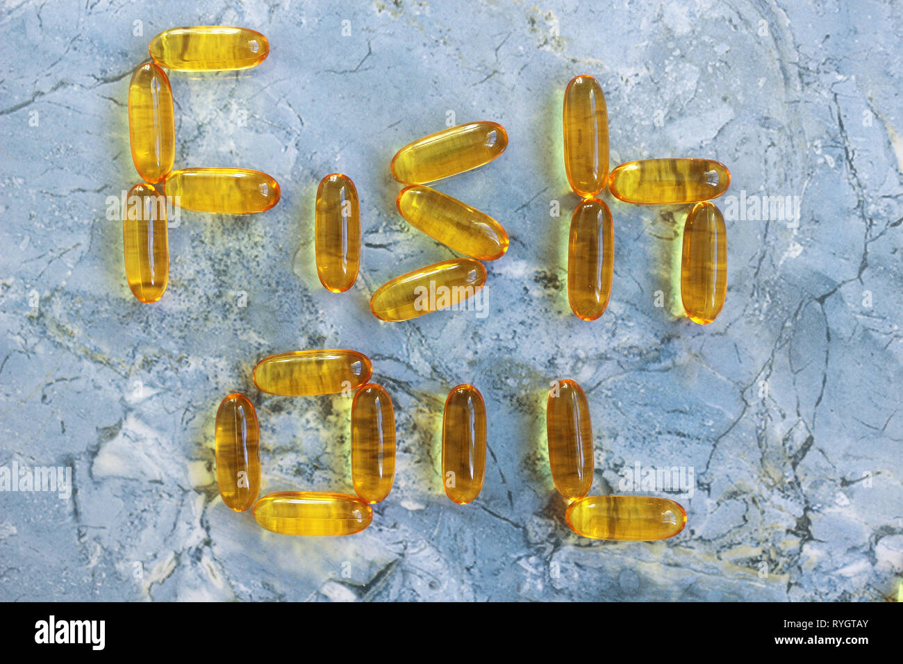 L'huile de poisson dans l'huile de foie de morue capsules sur un arrière-plan en bleu Banque D'Images