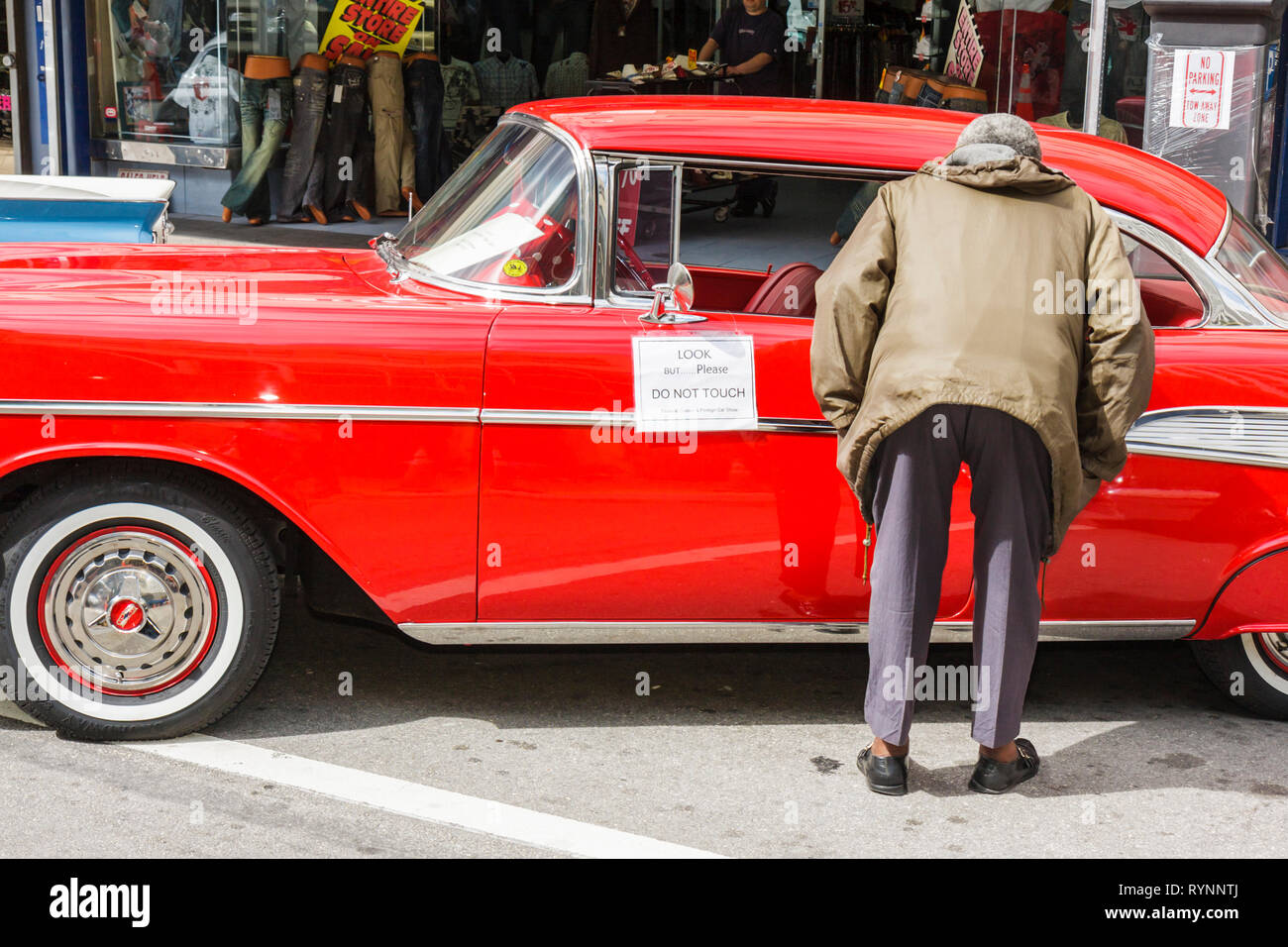 Miami Florida,centre-ville,Flagler Street,Bike Miami Days,Community Classic car,1957 Chevrolet,auto,man men male,look,Red Paint,sign,look do not touch, Banque D'Images
