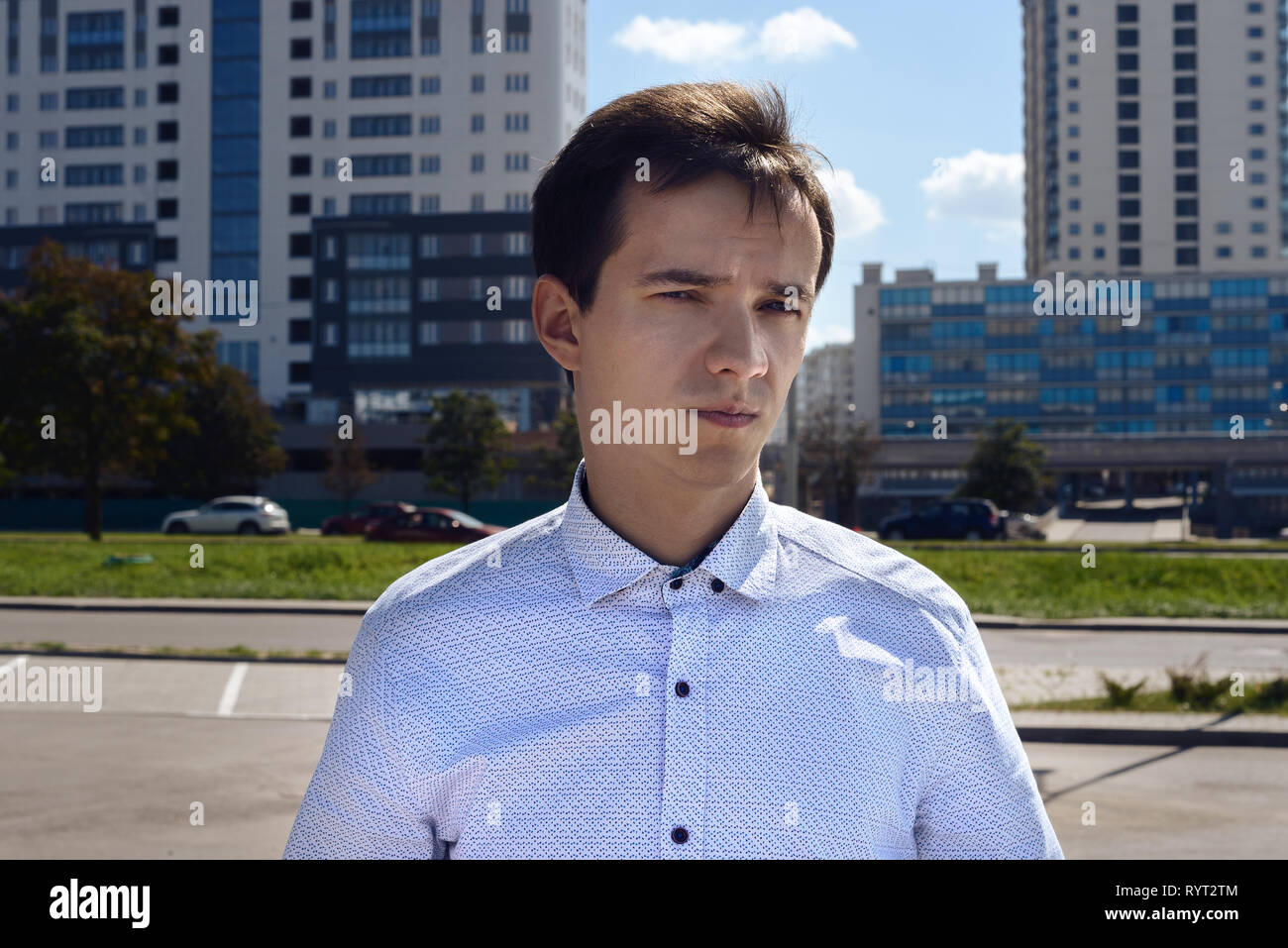 Portrait of a young caucasian gars en chemise dans la ville. à l'arrière-plan du bâtiment Banque D'Images