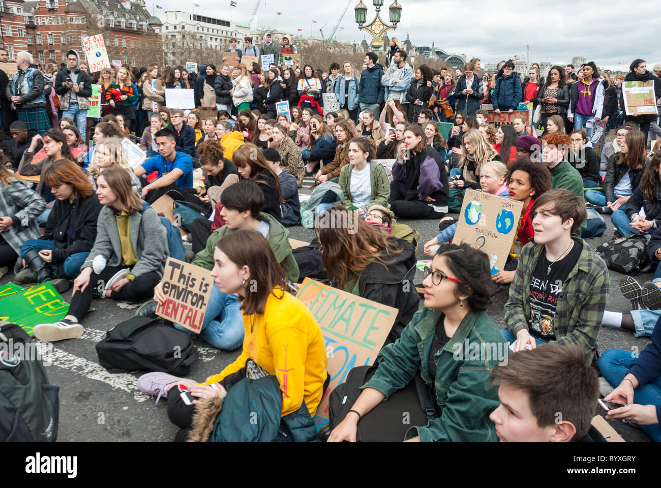 Londres, Royaume-Uni. 15 mars, 2019. Les élèves de l'école de campagne contre le changement climatique protester à l'extérieur du Parlement. Credit : Maggie sully/Alamy Live News. Les enfants de l'école en grève pour protester contre le changement climatique se rassemblent à l'extérieur du Parlement, Londres, et ont une protestation s'asseoir sur le pont de Westminster qui le bloque à tous grâce à la circulation. Il y a ensuite une rencontre animée avec de nombreux jeunes orateurs de répondre aux préoccupations des jeunes sur la justice climatique et le réchauffement climatique. Bannières : 'c'est l'environnement'. Une partie de la protestation dans le monde entier 'FridaysforFuture'. Banque D'Images