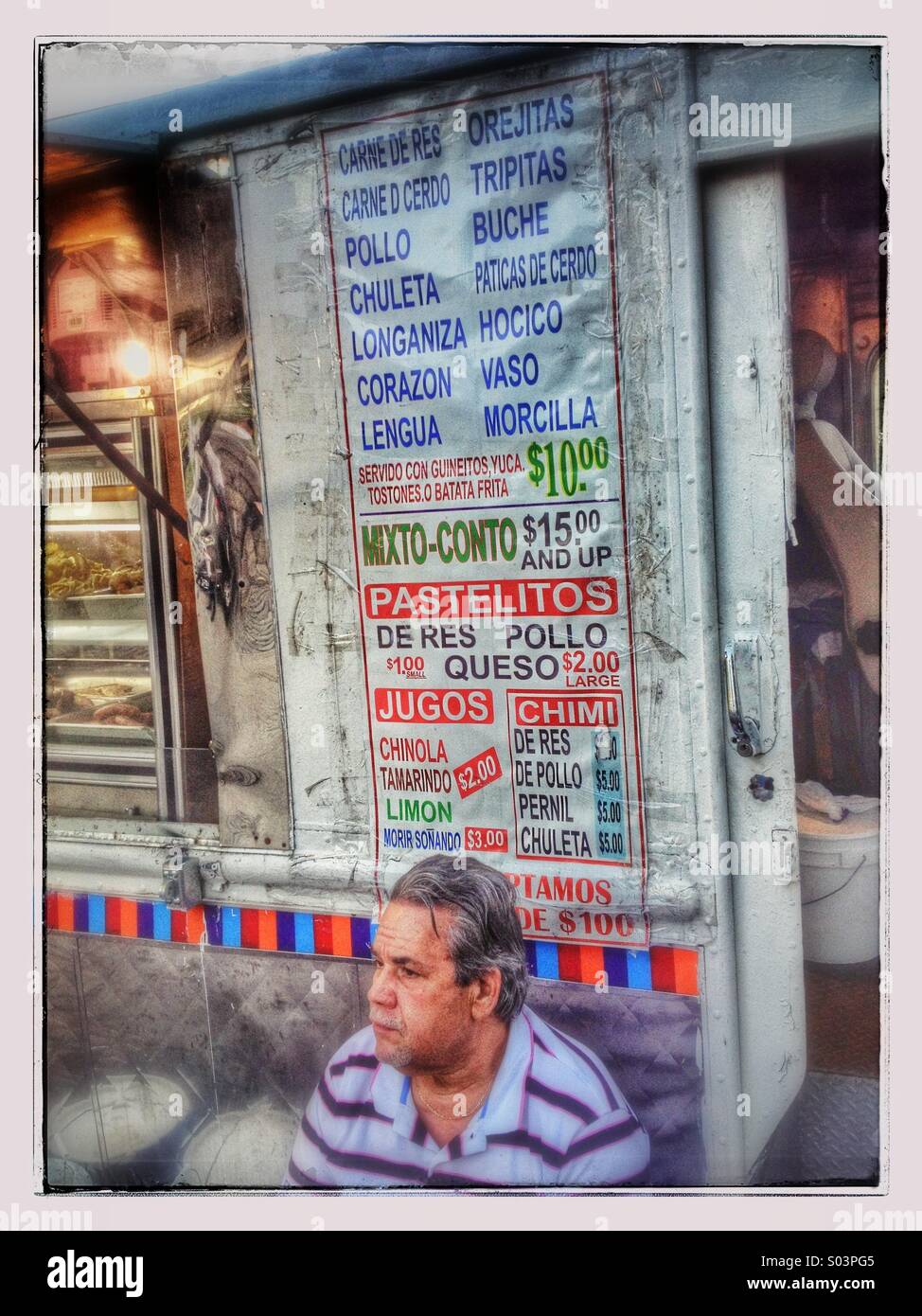 Homme assis en vertu de l'inscription sur le côté du camion alimentaire chimichurri Banque D'Images