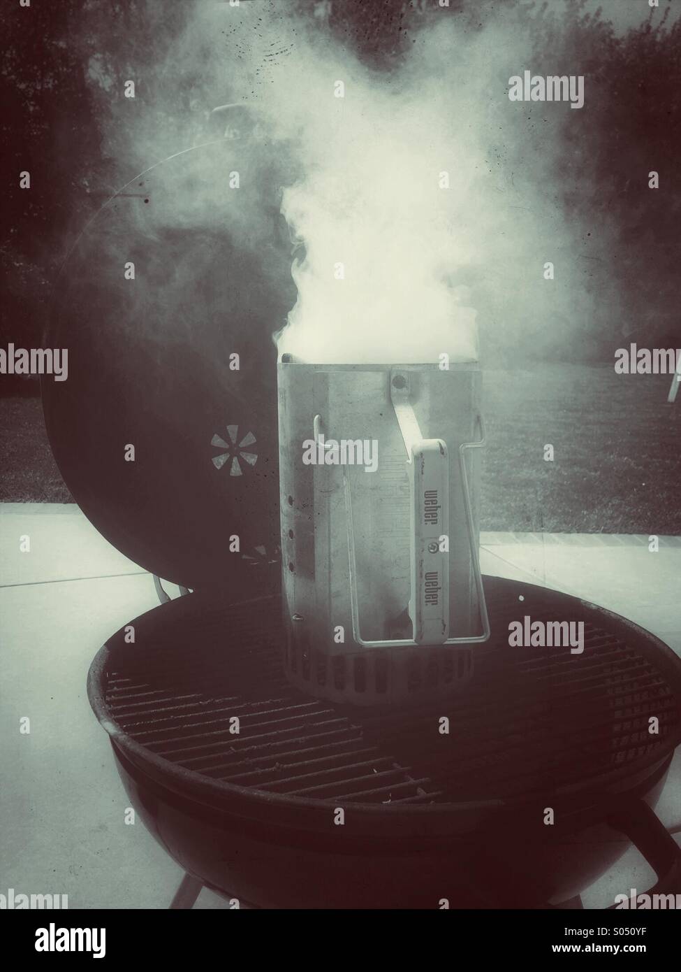 Un charbon de bois cheminée fume alors que le chauffage charbon sur une chaude journée d'été Banque D'Images