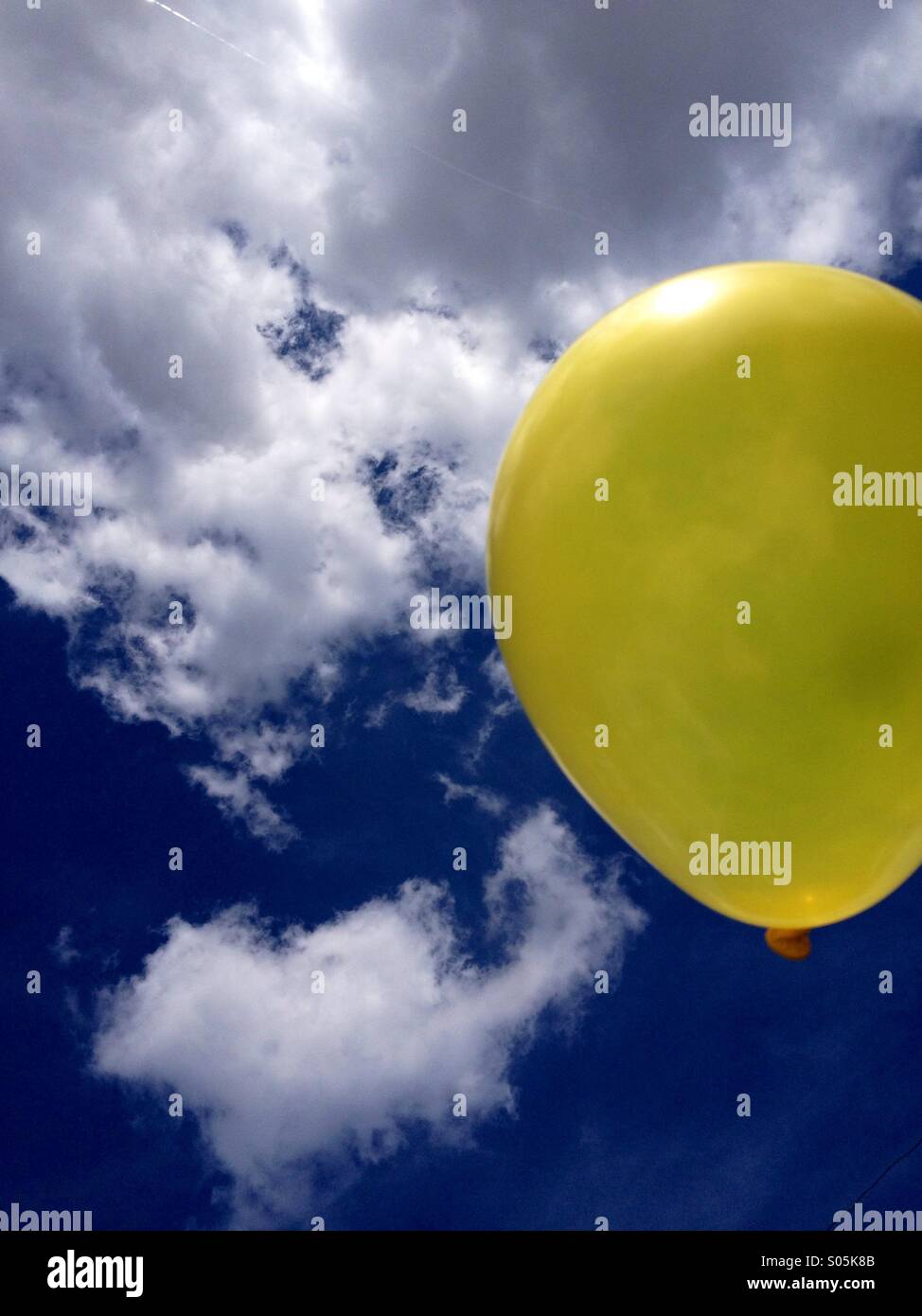 Ballon jaune flottant dans le ciel Banque D'Images Ballon jaune flottant dans le ciel Banque D'Images