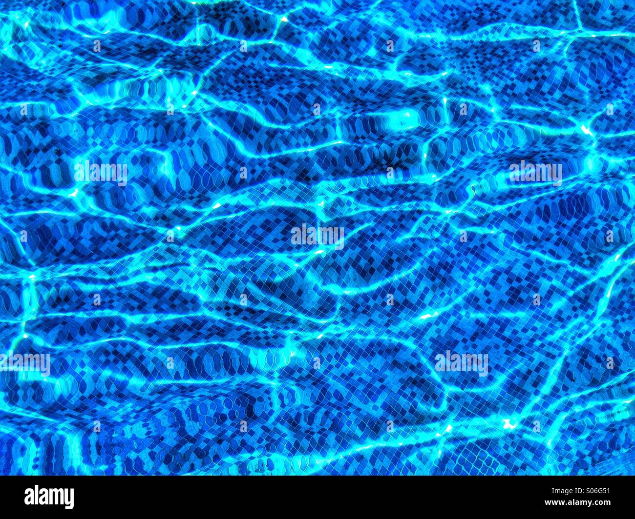 Les ondulations de l'eau de carreaux de mosaïque bleue et déformée dans une piscine. Crédits photos - © COLIN HOSKINS. Banque D'Images