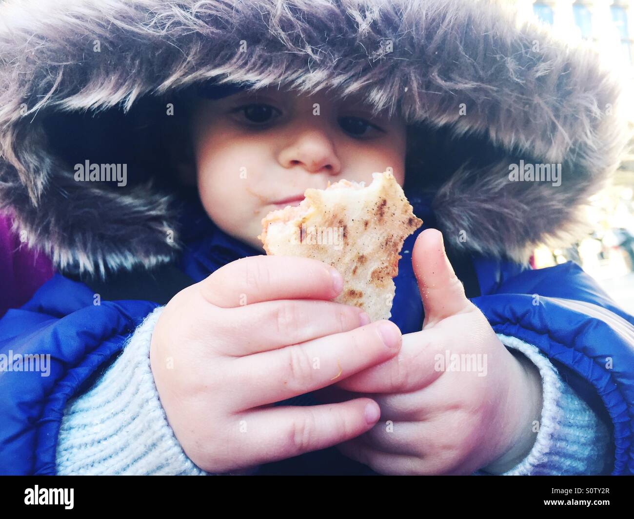 Un an baby eating pizza par elle-même Banque D'Images