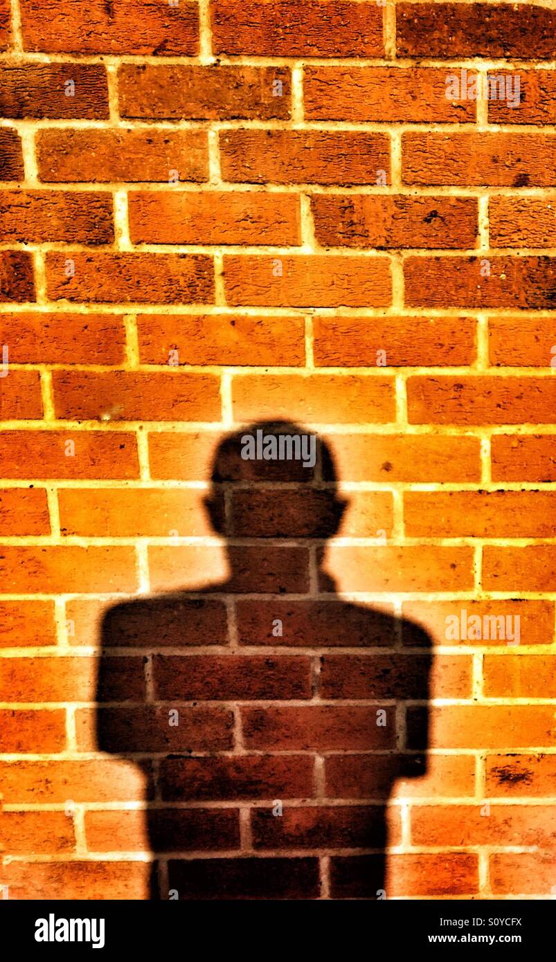 Ombre selfies sur un mur de briques Banque D'Images
