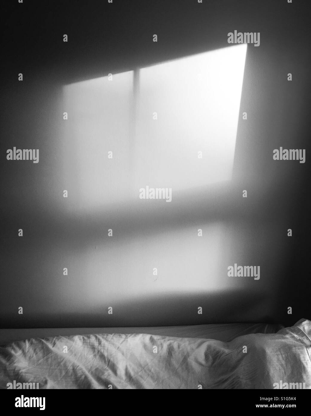 La lumière du soleil sur un mur dans une chambre à coucher Banque D'Images