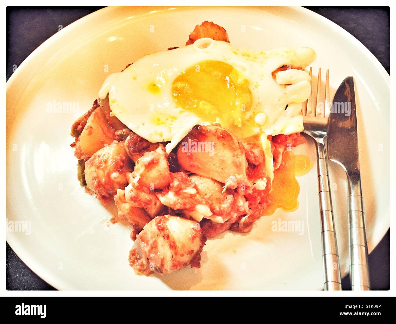 Le corned-beef Hash surmonté d'un œuf frit. Banque D'Images