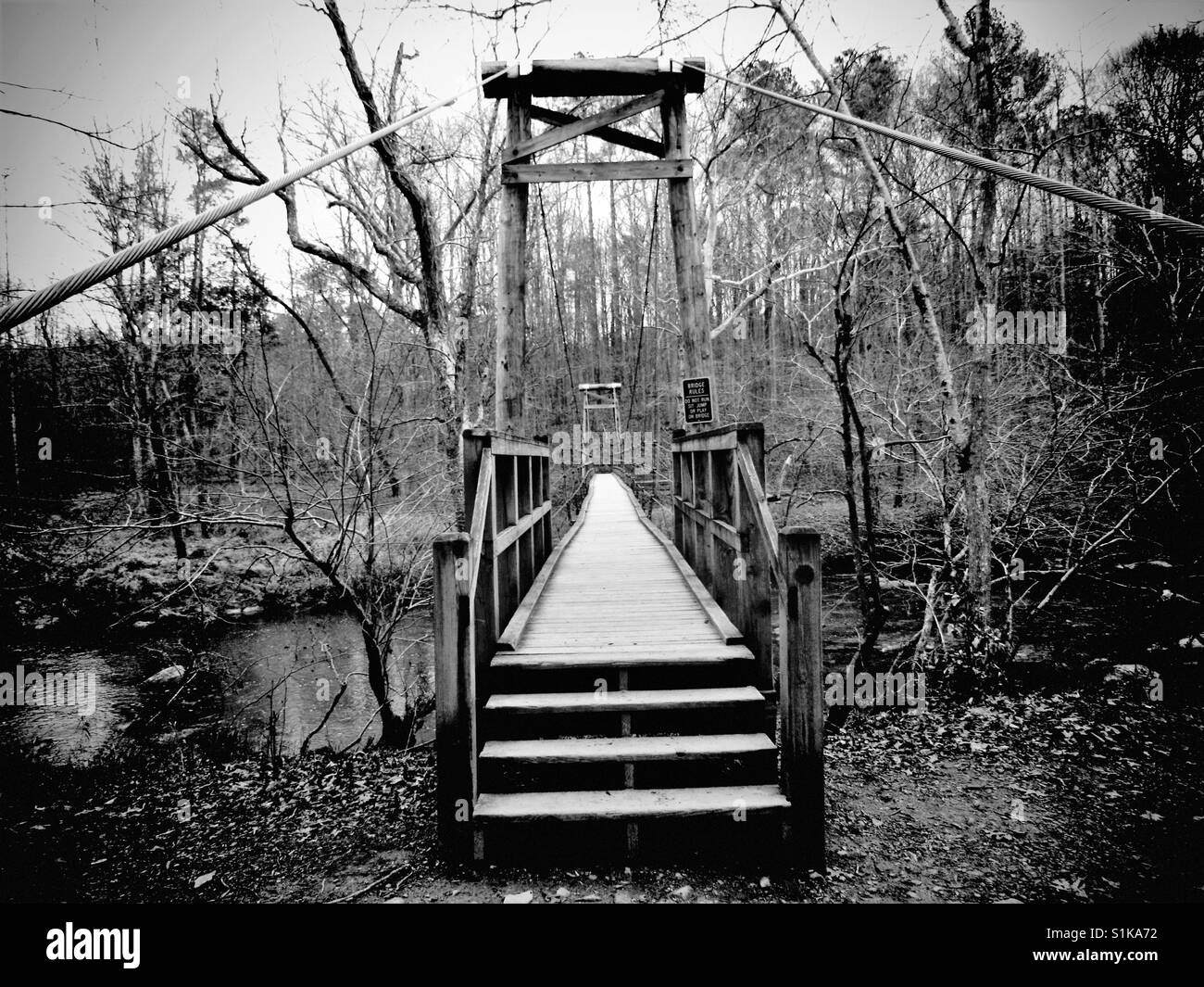 Pont noir et blanc en bois, dans un parc en Caroline du Nord Banque D'Images