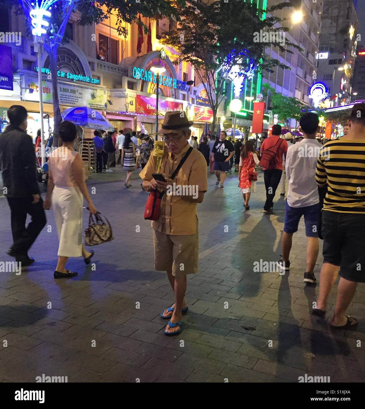 Perdu dans la technologie au cours des célébrations du Nouvel An chinois à Ho Chi Minh City - Image de stock capturée avec un smartphone