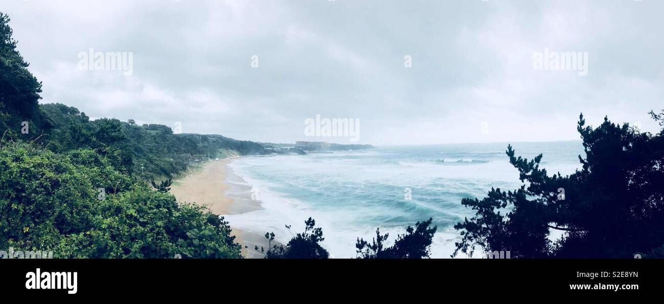 Une photo panoramique d'une plage sur l'île de Jeju, en Corée du Sud dans un ciel couvert mais chaude journée. Banque D'Images