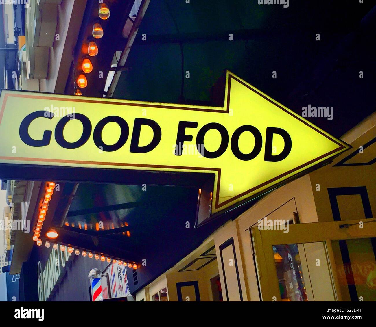 Signe en forme de flèche pointant vers un restaurant qui propose de la bonne nourriture, de Times Square, New York, USA Banque D'Images