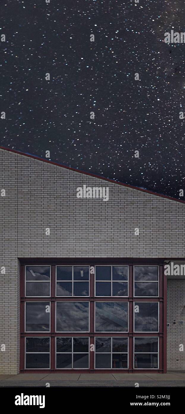 Un bâtiment avec une fenêtre qui a de nombreux volets carrés contre un ciel étoilé - Image de stock capturée avec un smartphone