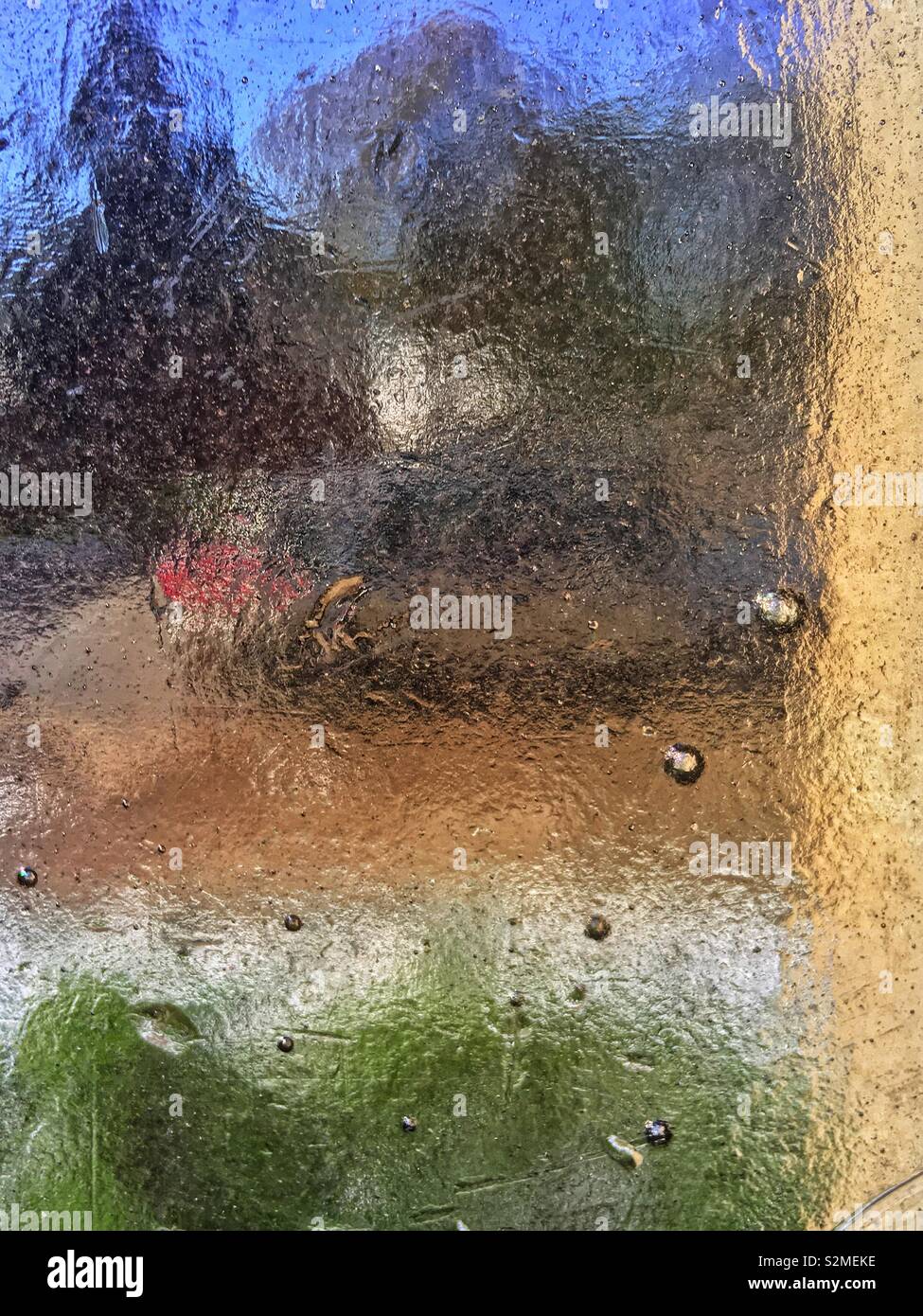 Couleurs vives de décoration beige vert et bleu texturé vitraux verre translucide avec un motif abstrait aléatoire. - Image de stock capturée avec un smartphone