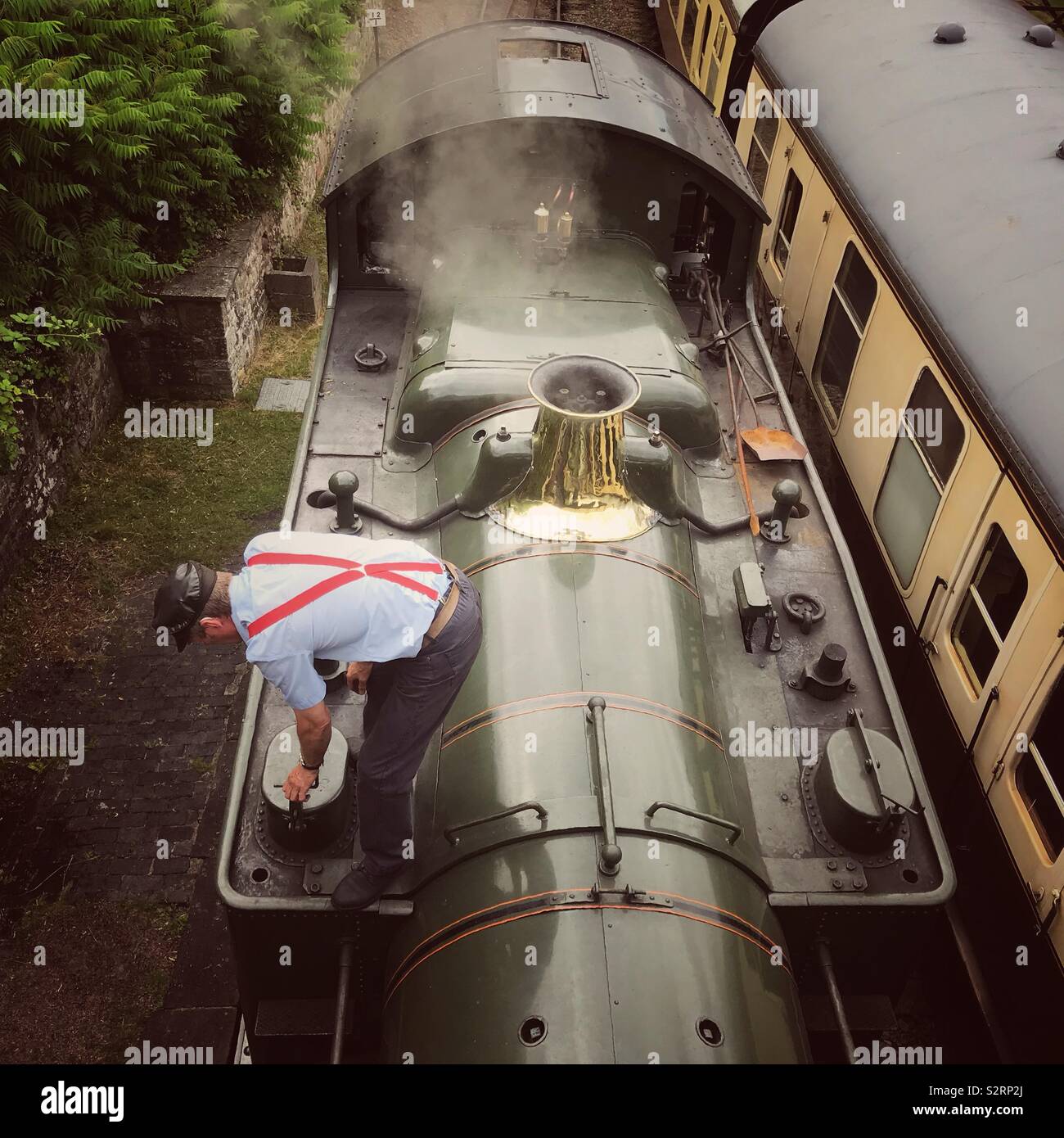Un pilote de moteur prépare un train à vapeur pour le service - Image de stock capturée avec un smartphone