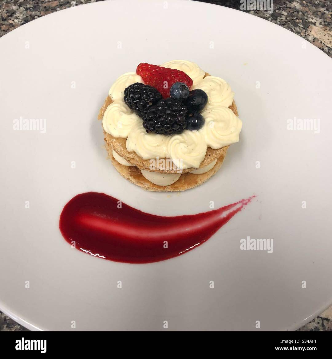 Mille-feuille avec crème de pâtisserie maison, baies fraîches et purée de framboises Banque D'Images