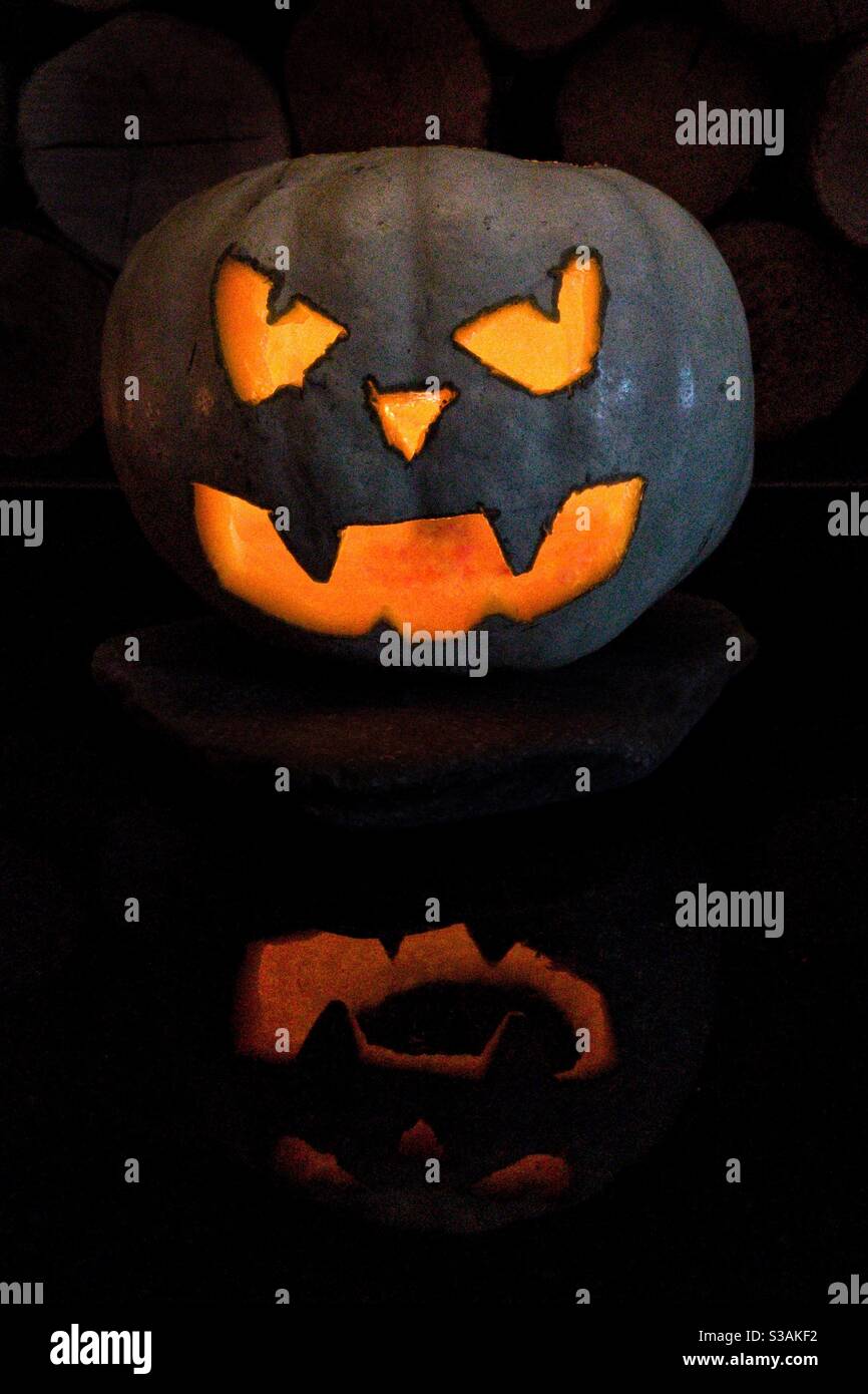 Citrouille blanche sculptée illuminée pour Halloween. Banque D'Images