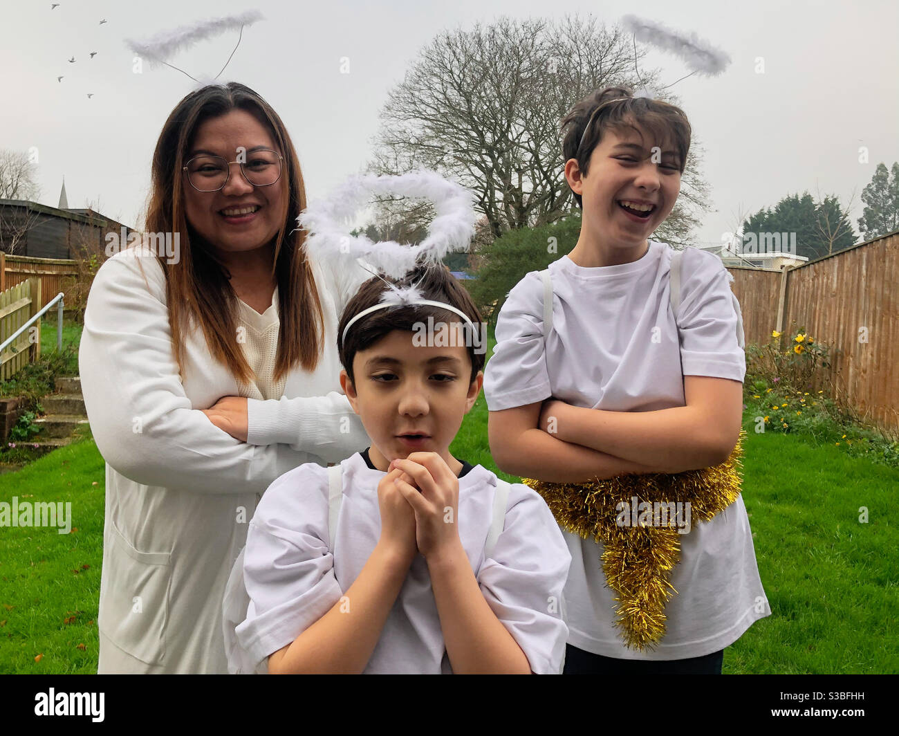 Une famille habillée d'anges pour participer à un spectacle de nativité. Banque D'Images