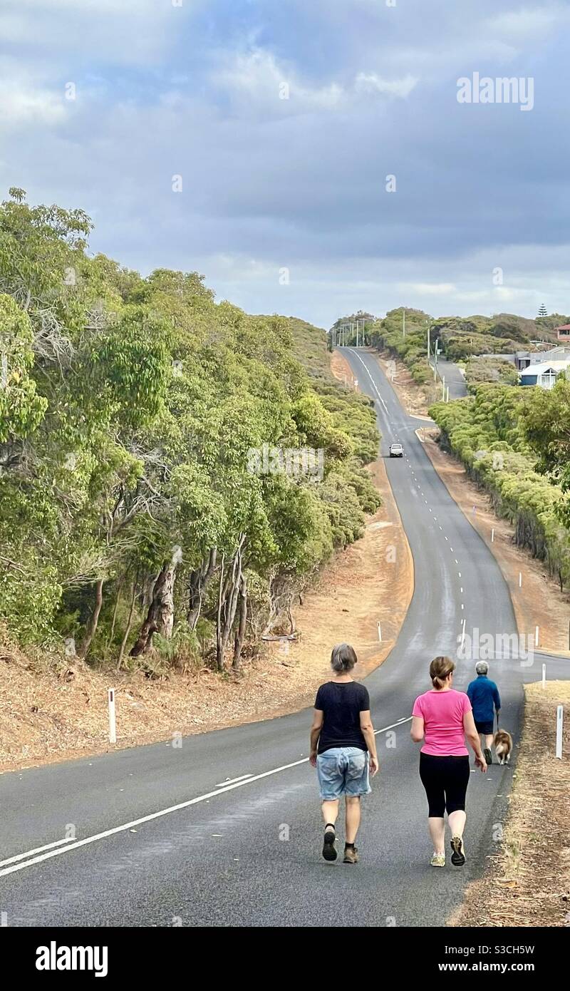Trois personnes marchant un chien sur une route à côté de Leeuwin-Naturaliste Parc national Augusta Australie occidentale Banque D'Images