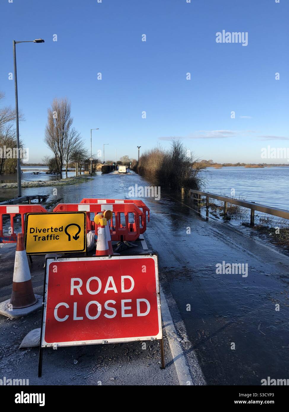 Une barrière et un panneau de route fermés en raison des inondations Banque D'Images