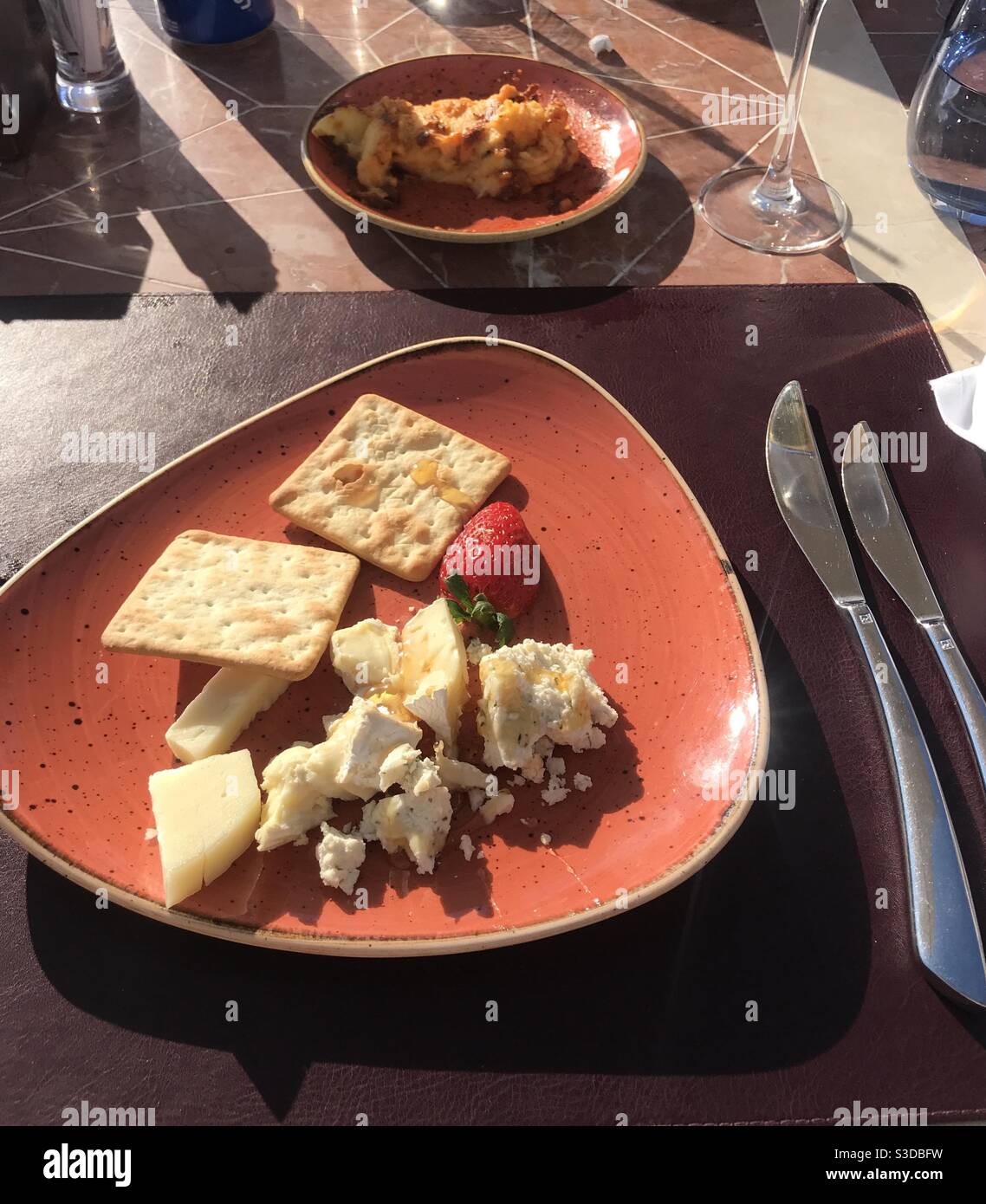 Plateau de fromages mélangés et de craquelins servis à l'extérieur terrasse du restaurant - Image de stock capturée avec un smartphone