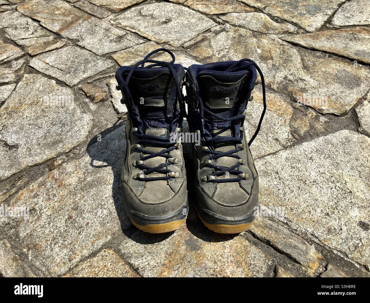 Getragene Jakobsweg Wanderstiefel am Platz vor der Kathedrale von Saint-Jacques-de-Compostelle Banque D'Images