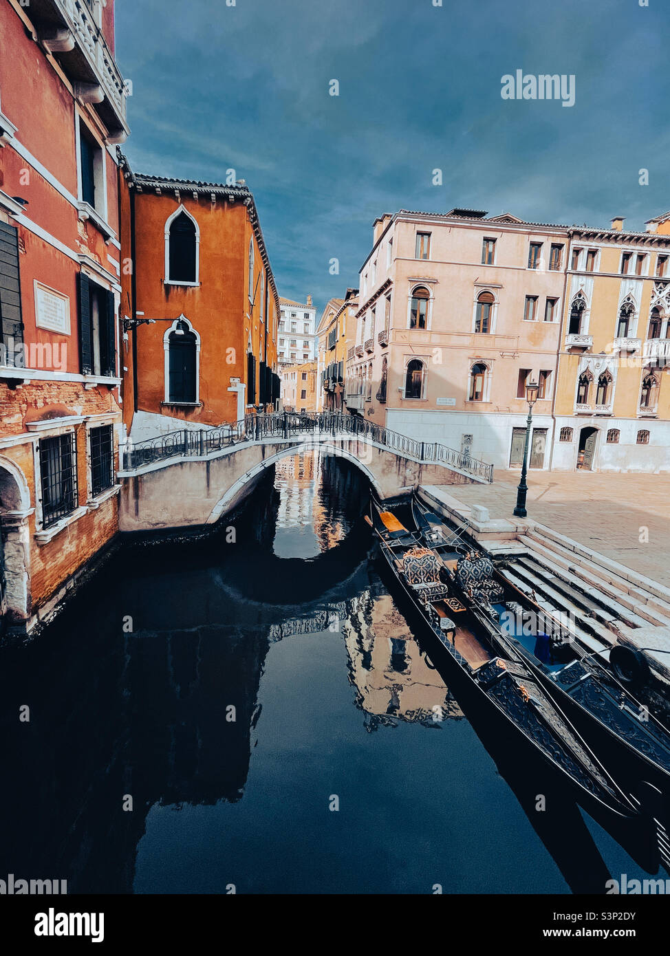 Gondoles assises dans un petit canal à Venise, en Italie, entouré de beaux bâtiments résidentiels. Banque D'Images