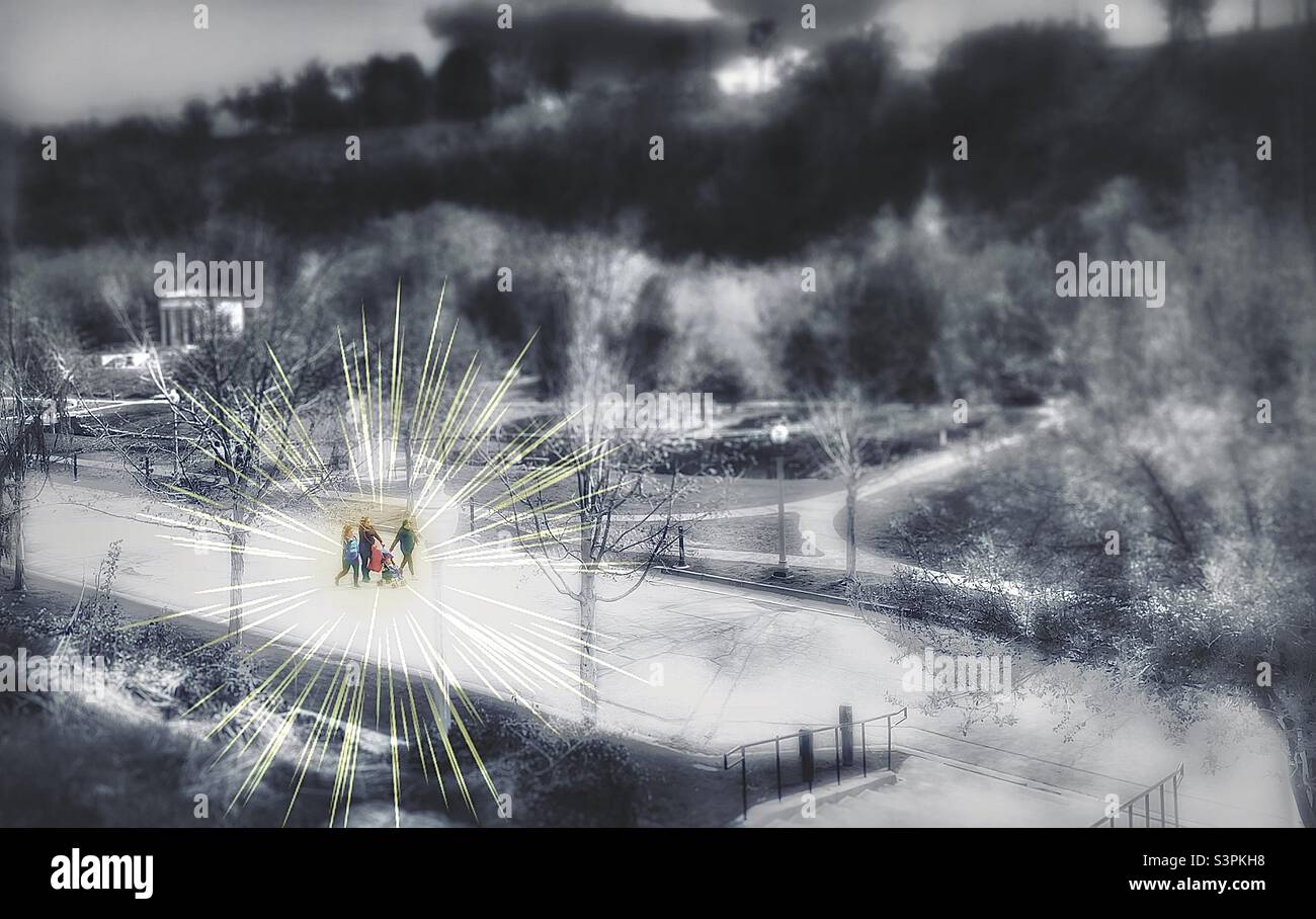 Une famille marche ensemble lors d'une belle journée de printemps à travers le parc commémoratif de Memory Grove à Salt Lake City, Utah. Une vue large, douce et désaturée du parc contraste avec les marcheurs mis en évidence. Banque D'Images