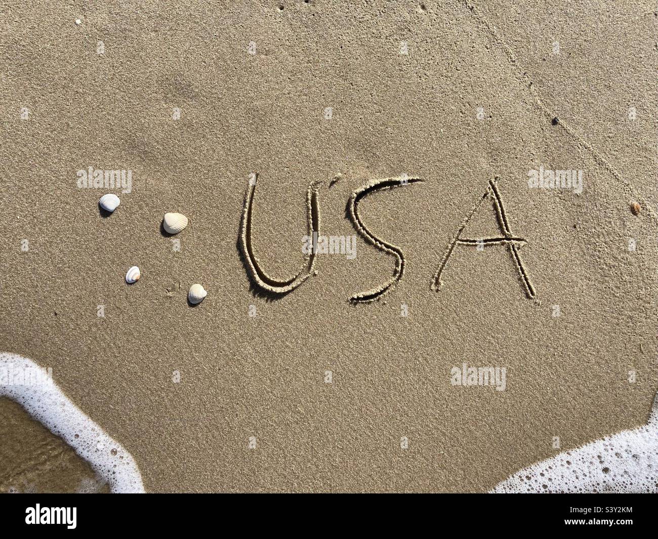 Sur la plage est sculpté avec des lettres dans le sable lisse l'écriture USA - Image de stock capturée avec un smartphone