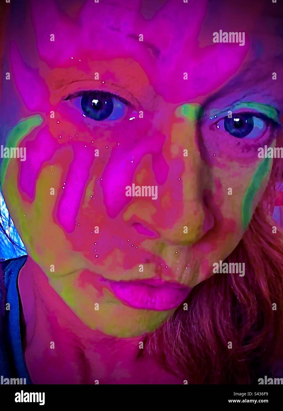 Face peinte. Portrait en gros plan du visage de la femme avec une peinture pour le visage au néon de couleur vive. - Image de stock capturée avec un smartphone