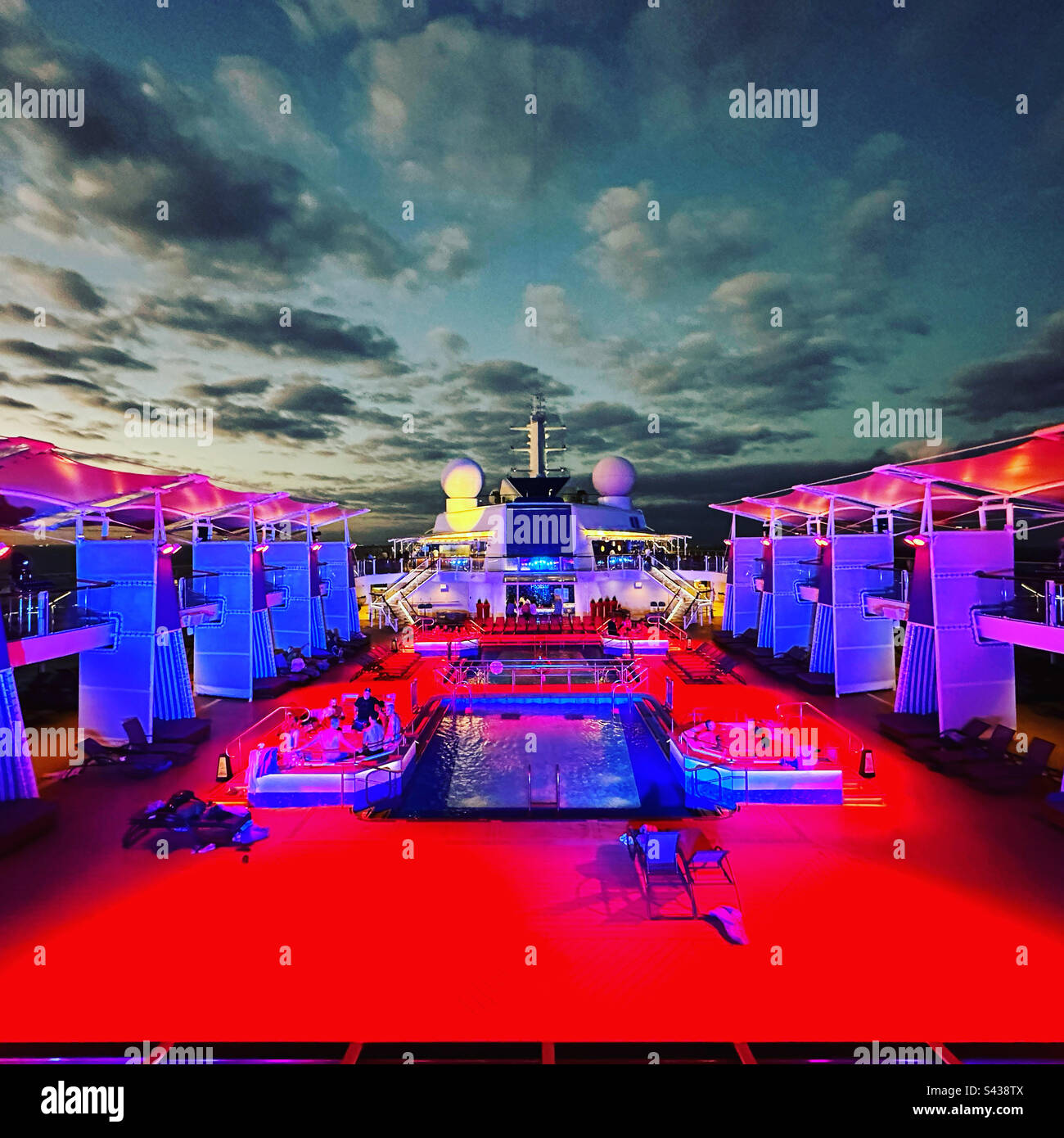 Lumières sur la terrasse de la piscine d'un bateau de croisière la nuit Banque D'Images