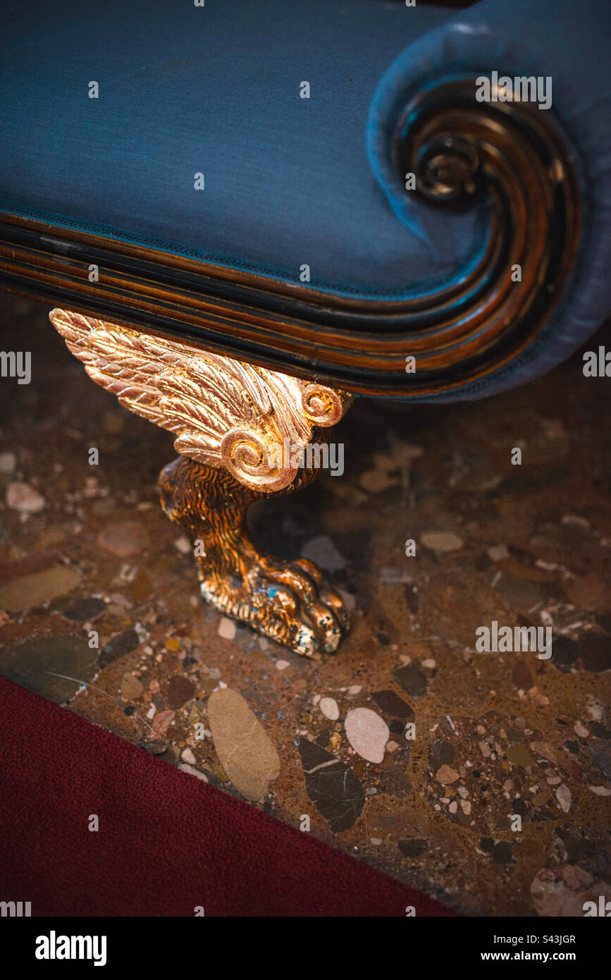 Pied de lions en bois sculpté avec ailes dorées. Banque D'Images