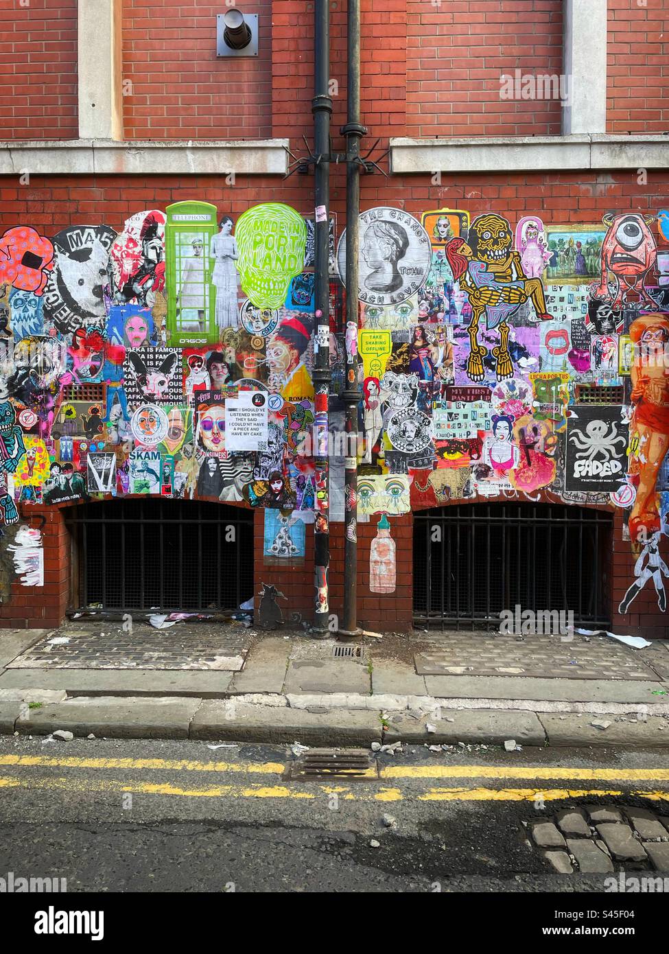 Volez des affiches sur un mur dans une rue latérale dans le quartier nord de Manchester. - Image de stock capturée avec un smartphone