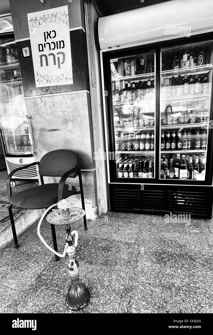 Un petit café servant des boissons et des pipes à eau fumantes à Jaffa, Israël. Banque D'Images