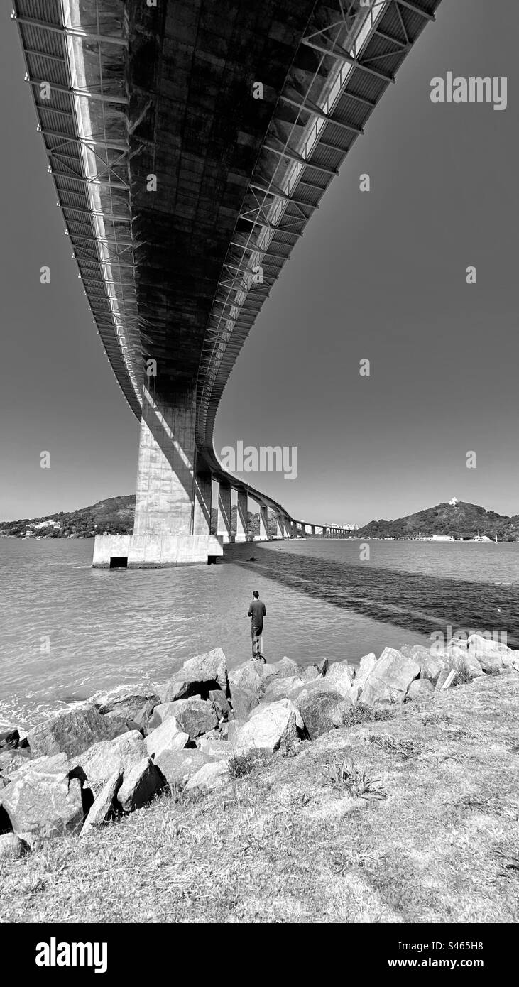 Homme debout sous le pont à Vitoria, Brésil Banque D'Images