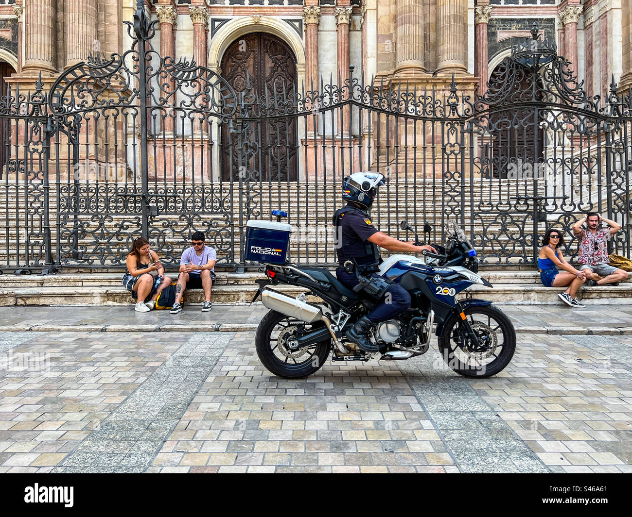 Police nationale conduisant la moto à travers Malaga Espagne Banque D'Images