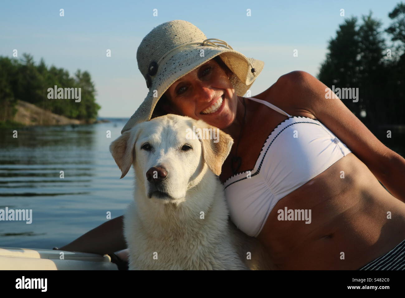 Fille et chien souriant, tout en bateau. - Image de stock capturée avec un smartphone