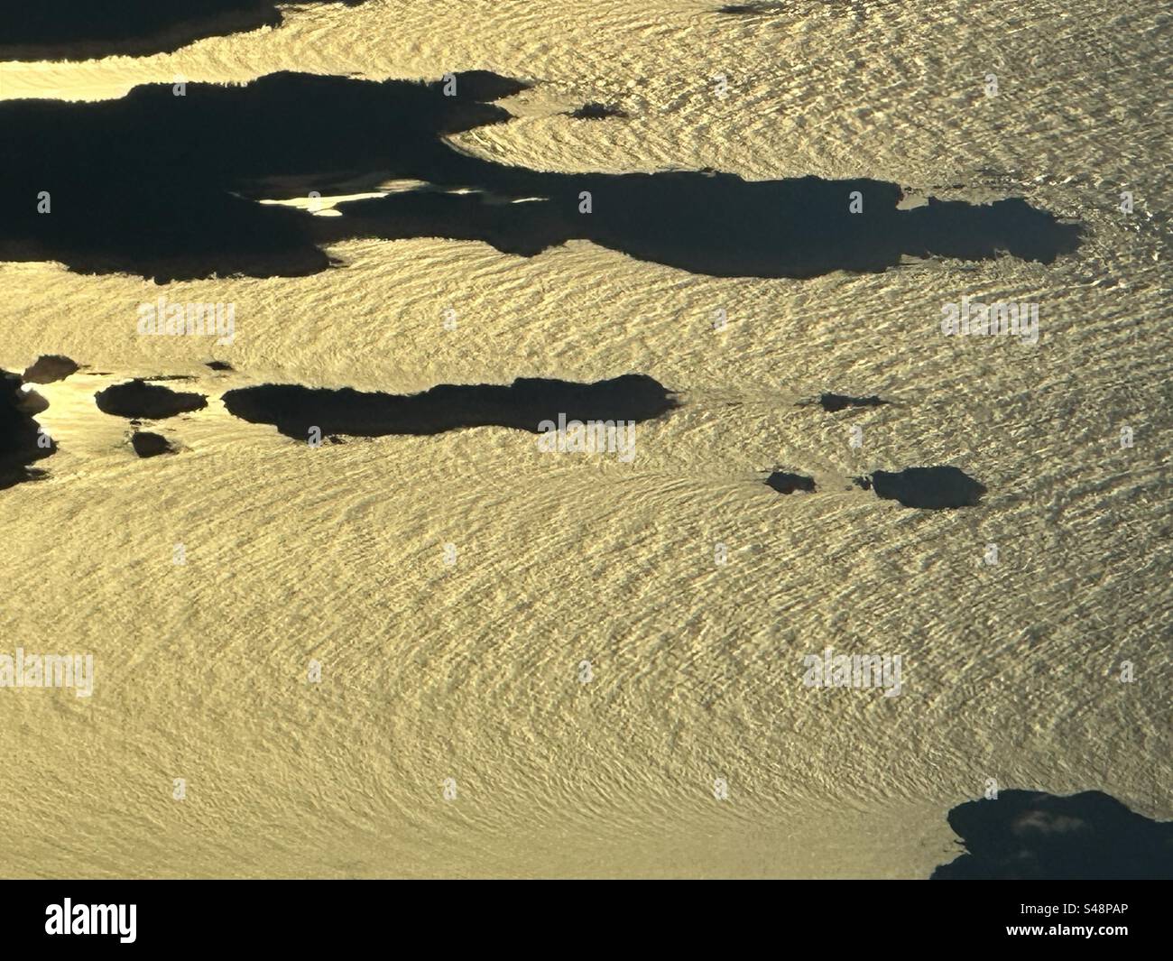 Îles au large des côtes de l'ouest du Canada dans un océan doré à l'aube. - Image de stock capturée avec un smartphone