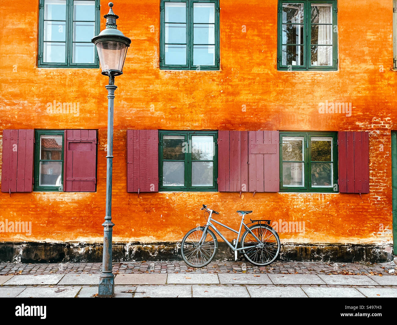 Vélo contre le bâtiment coloré de l'ancienne caserne navale de Nyboder. Copenhague, Danemark - Image de stock capturée avec un smartphone