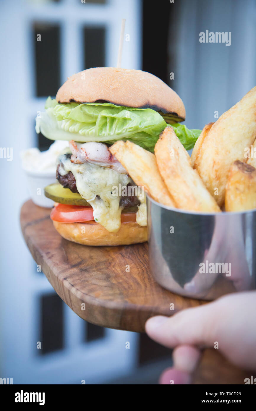 Burger de boeuf servi sur planche de bois Banque D'Images