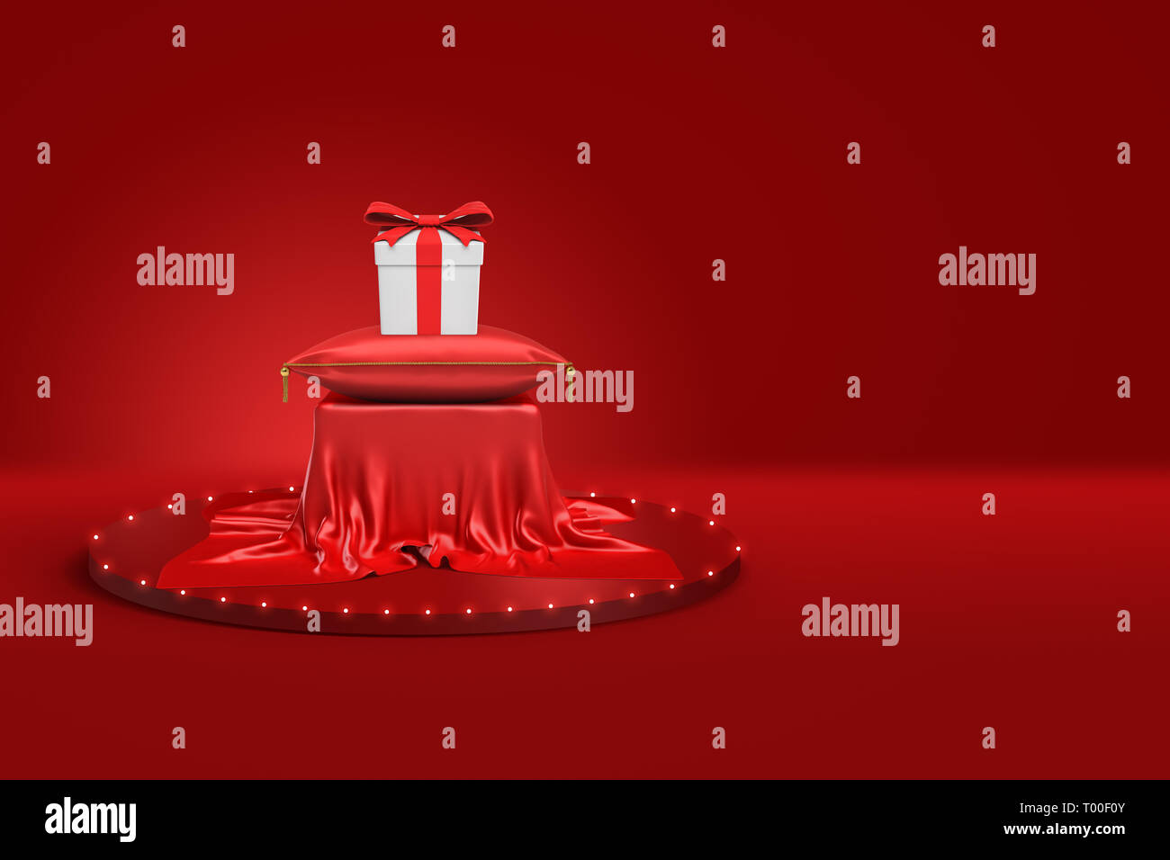 Le rendu 3D de boîte-cadeau blanche avec ruban rouge le coussin rouge et son socle recouvert de tissu rouge sur fond rouge Banque D'Images