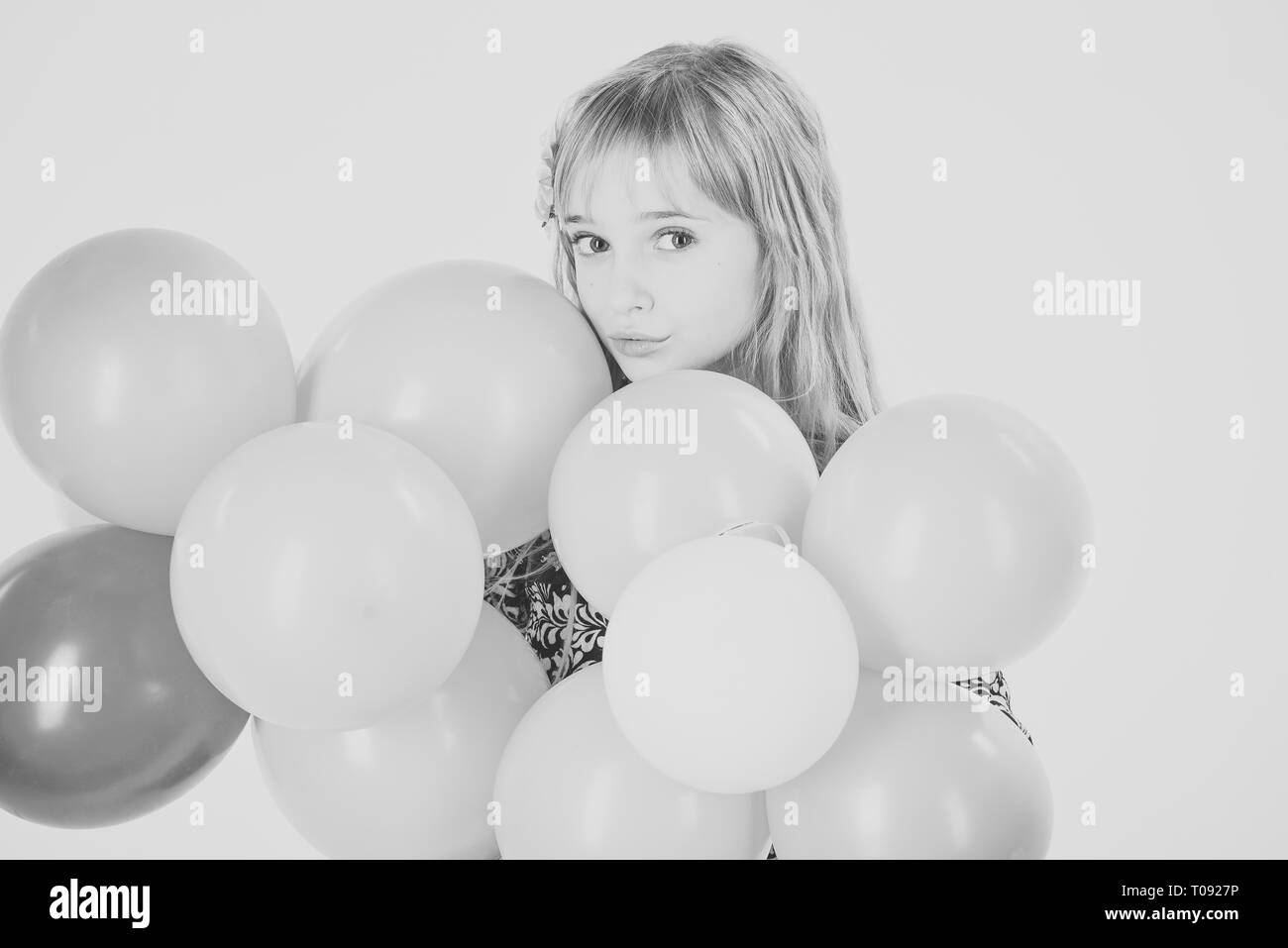 Petite fille aux ballons coiffure tenir. De la beauté et de la mode, punchy pastels. Kid avec des ballons à l'anniversaire. Les petites filles avec des ballons parti Banque D'Images