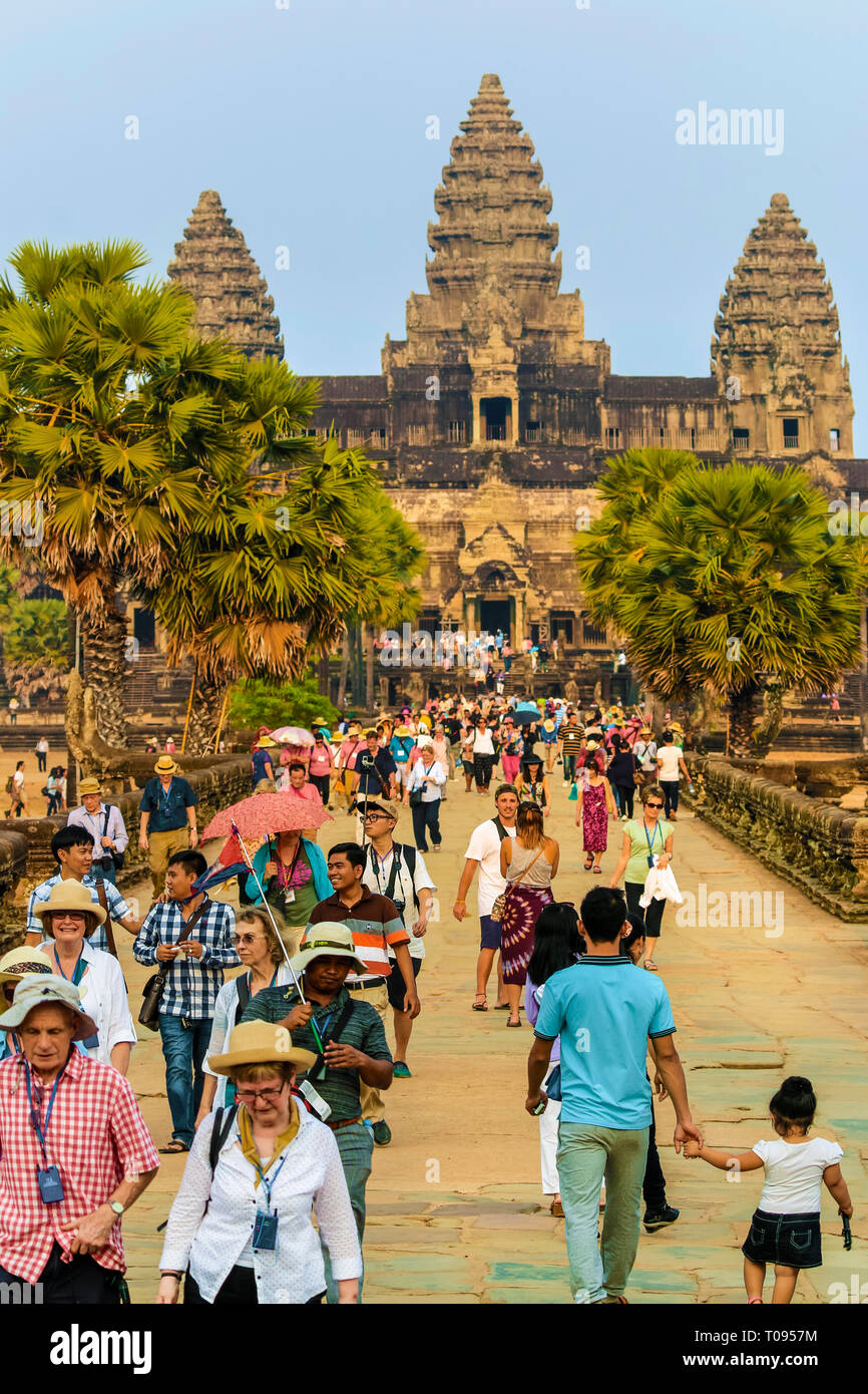 Foules touristiques sur l'entrée de pont-jetée de grès célèbre 12thC Angkor Wat temple complexe, 7e merveille du monde, Angkor, Siem Reap, Cambodge. Banque D'Images