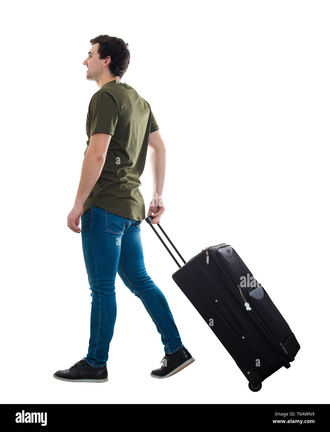 Portrait de jeune homme traveler portant sa valise matériel roulant. Homme d'attente des passagers taxi pour déplacement vers l'aéroport isolated over white background Banque D'Images