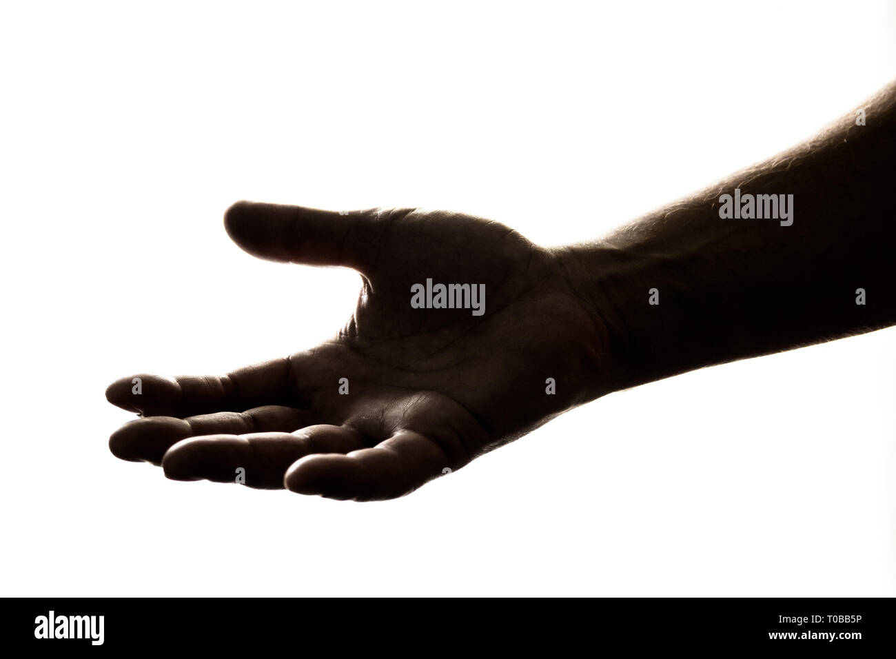Silhouette of hand reaching out de donner, ou de recevoir de l'aide/argent/espoir/Don. Banque D'Images
